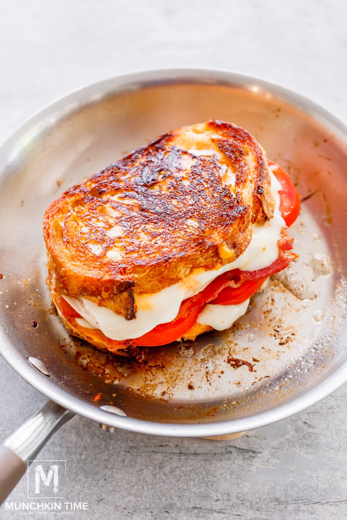 grilled cheese chicken sandwich cooking in the skillet. 