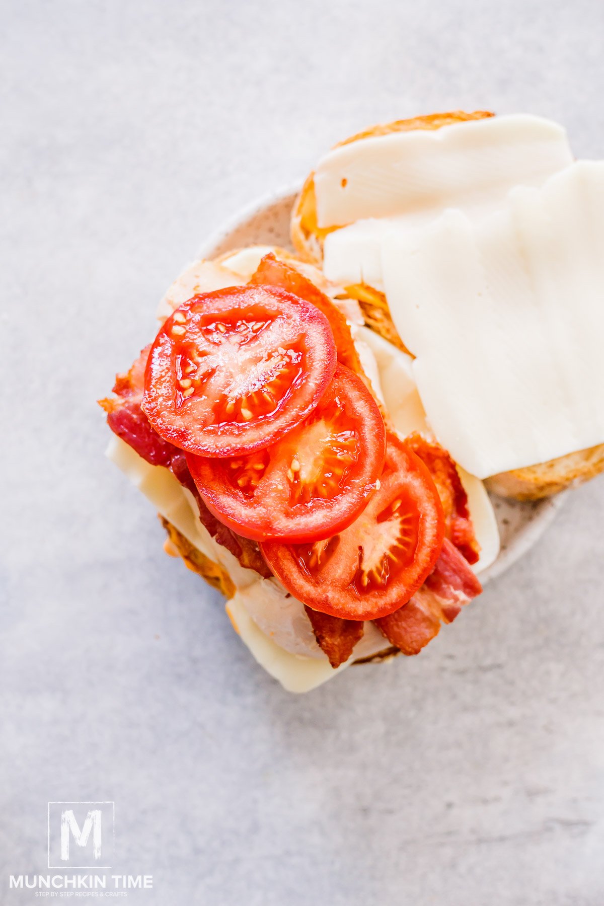 Tomato added to the top of the chicken and bacon.