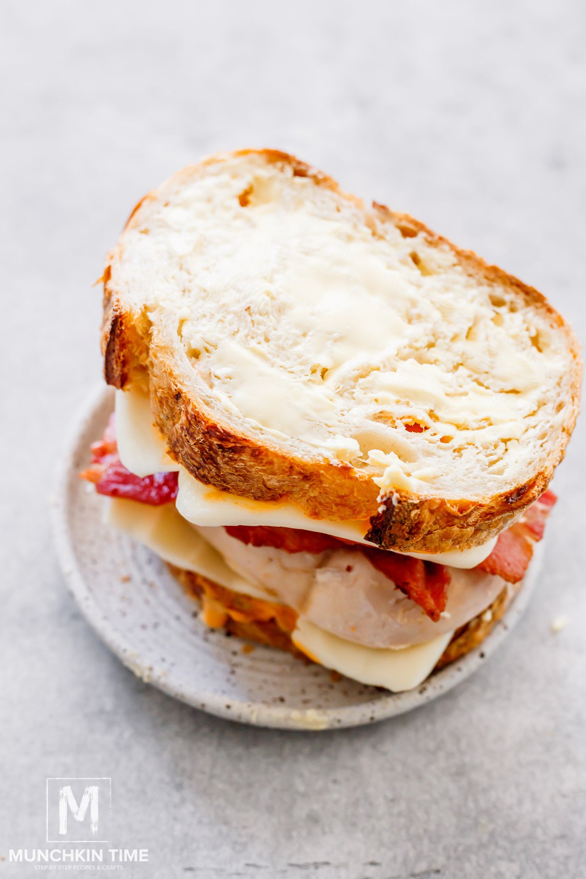 sourdough bread slice added to the top of the chicken sandwich.