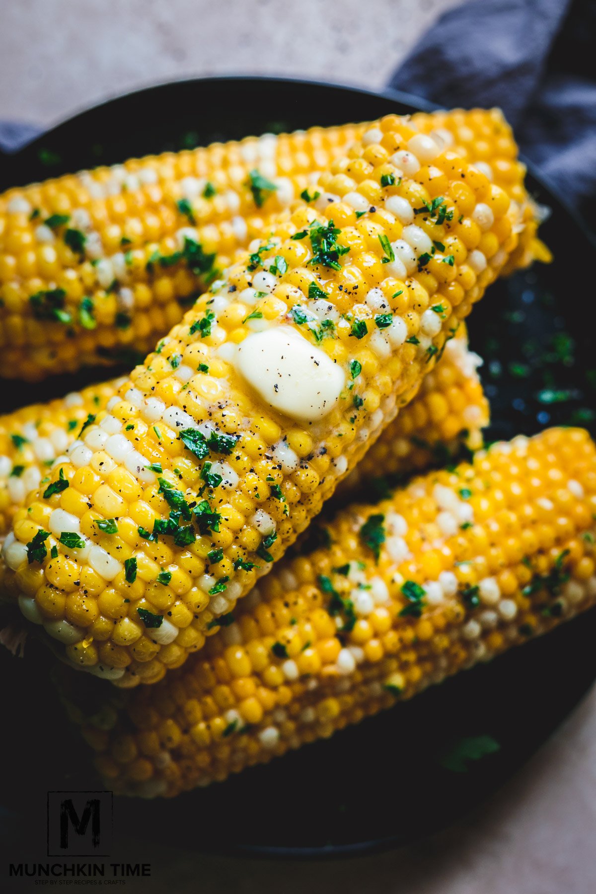 freshly cooked corn with butter and herbs. 