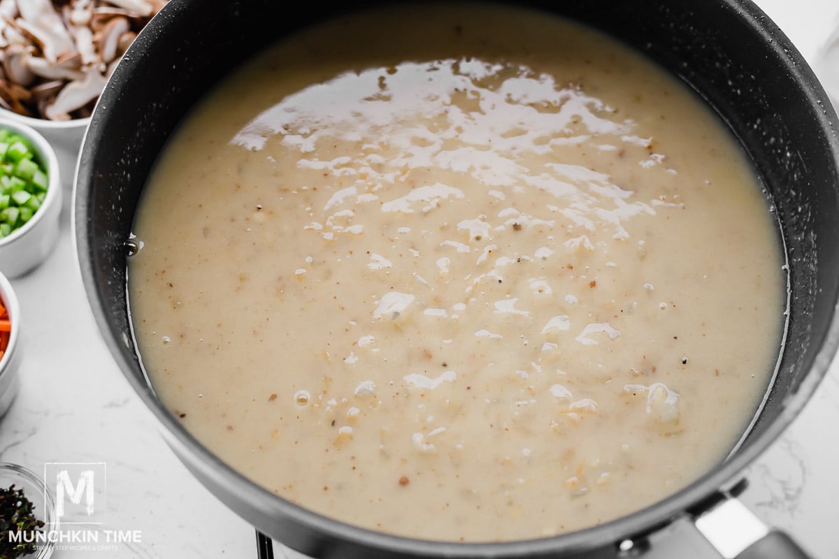 chicken broth and cream added to the skillet with onion.