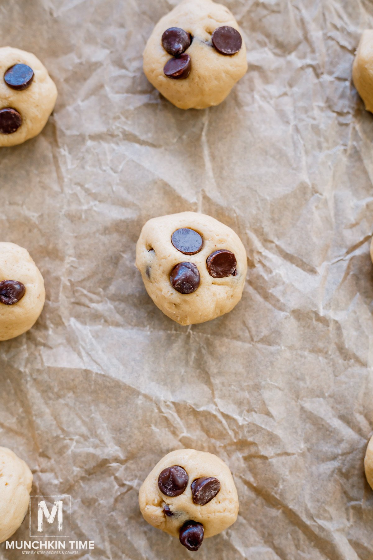 3 chocolate chips placed on each cookie dough balls before baking.