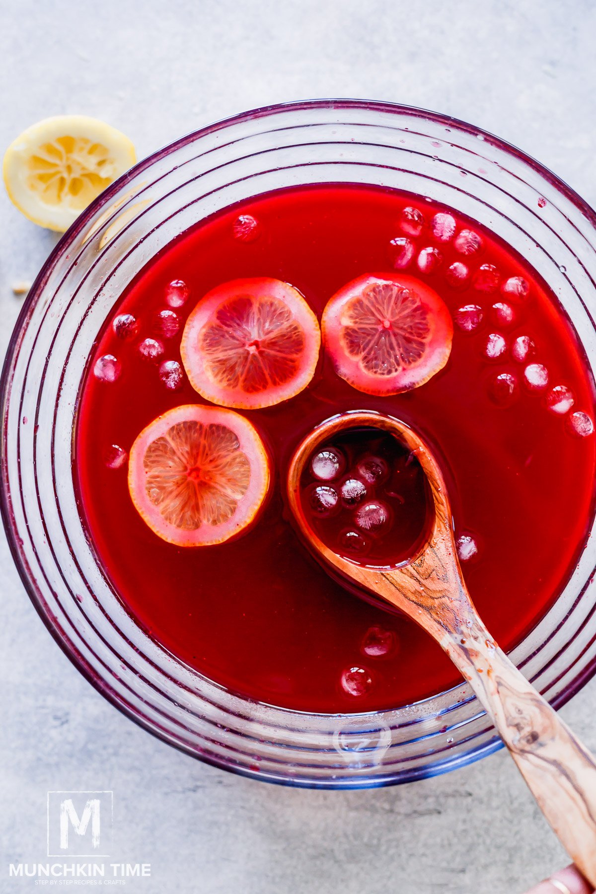 Huckleberry Lemonade in a big bowl with ice and lemons.