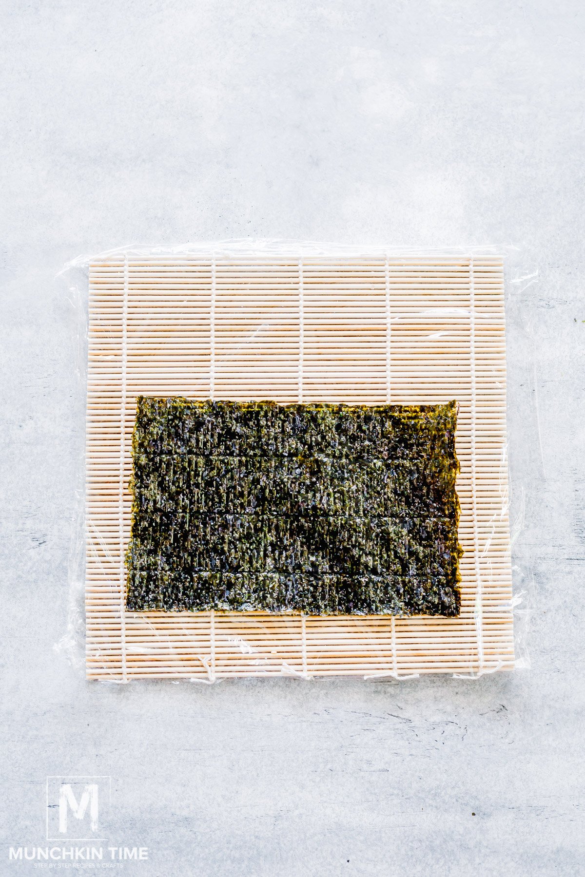 nori sheet laying on top of the bamboo mat.