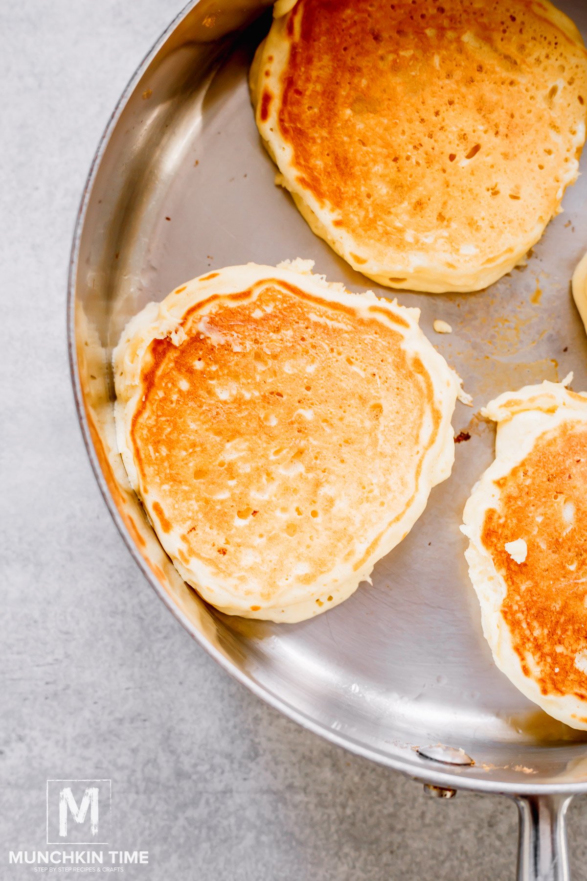 pancakes cooking in the skillet.