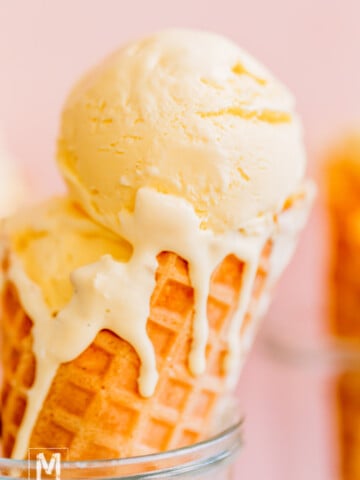 Homemade vanilla bean ice cream in a waffle cone.