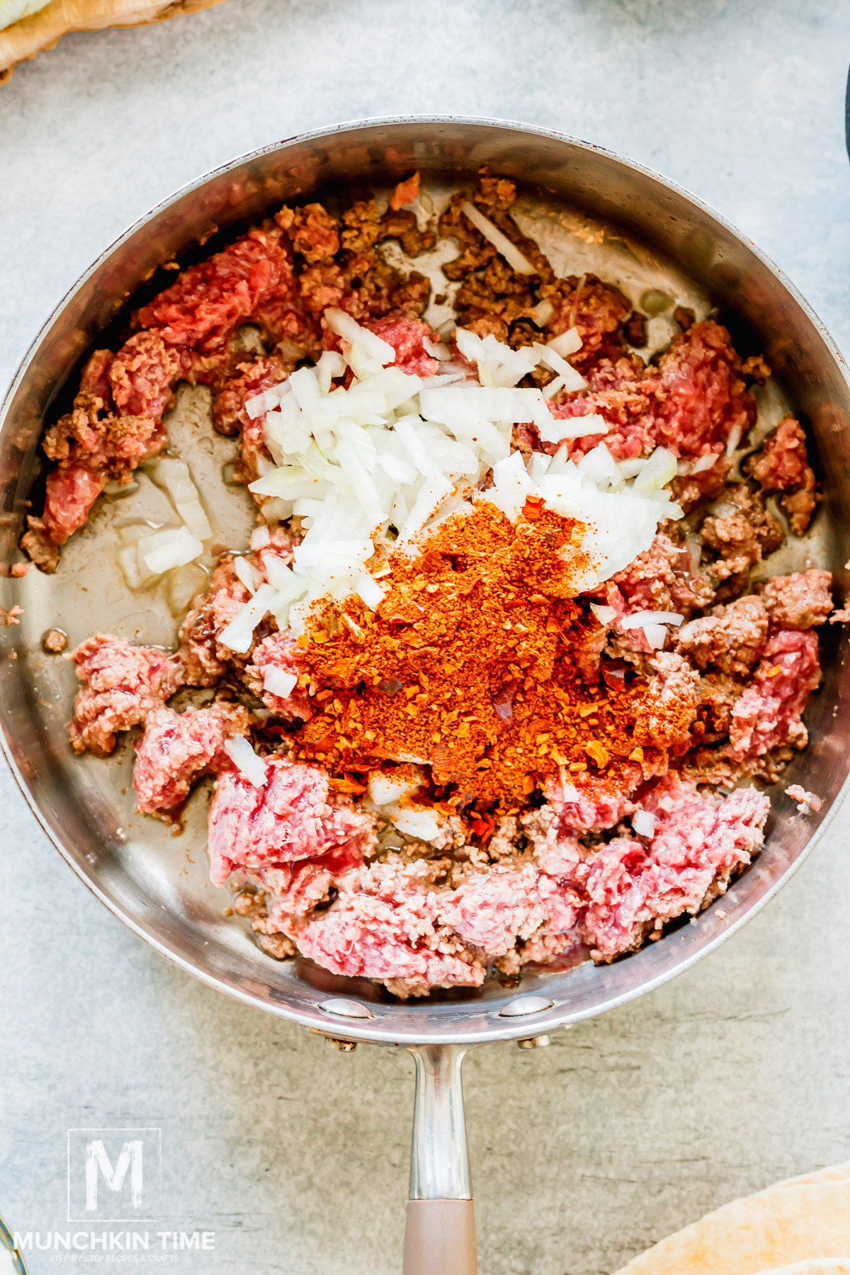 Spices added to the skillet with beef.