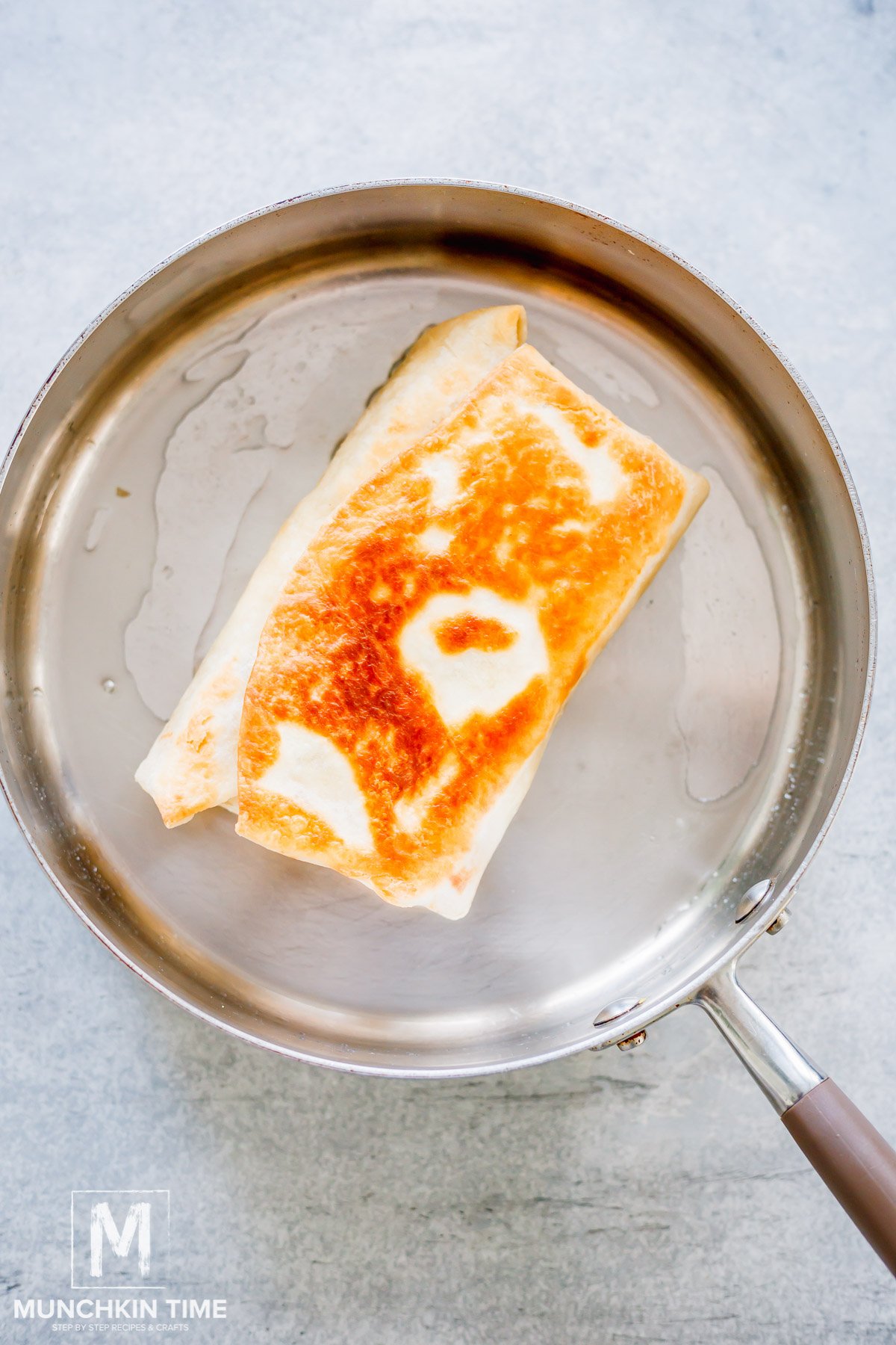 Burrito cooking in the skillet.