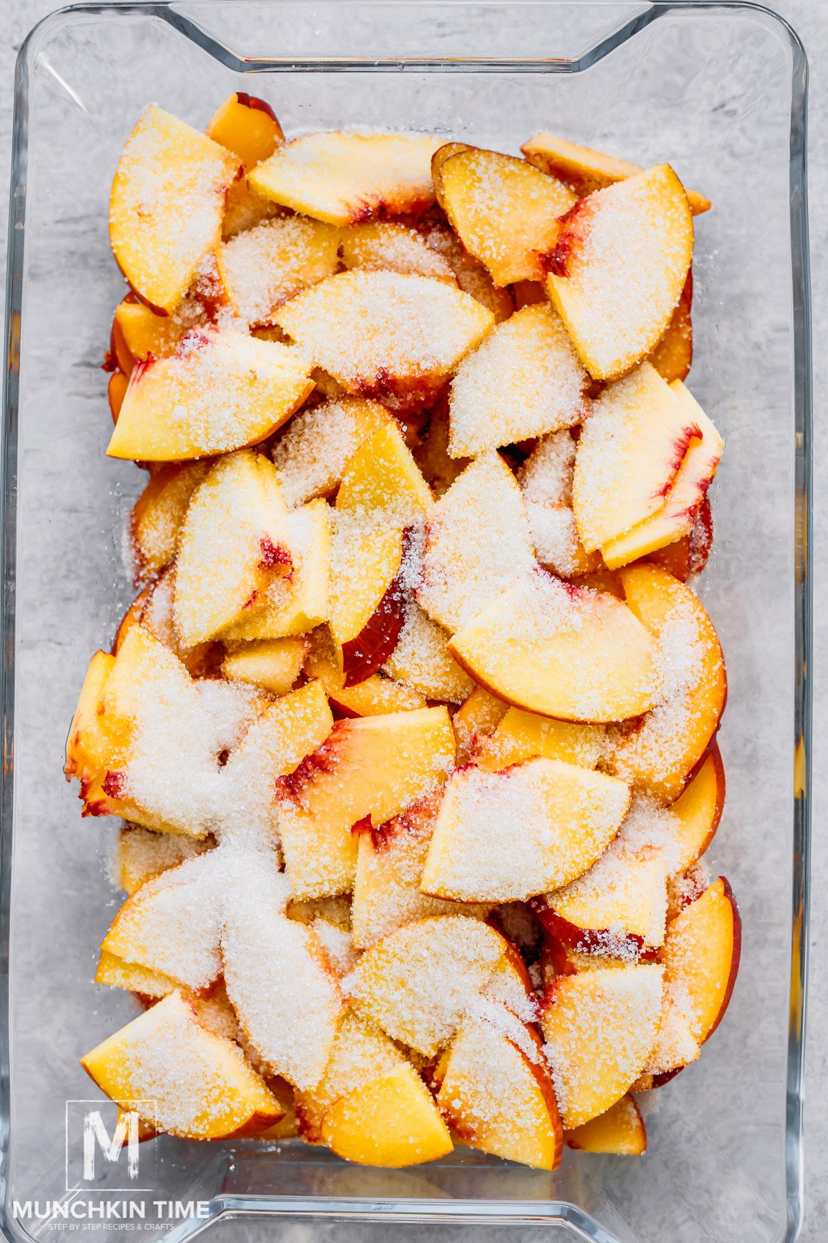 Sugar sprinkled over the peaches.