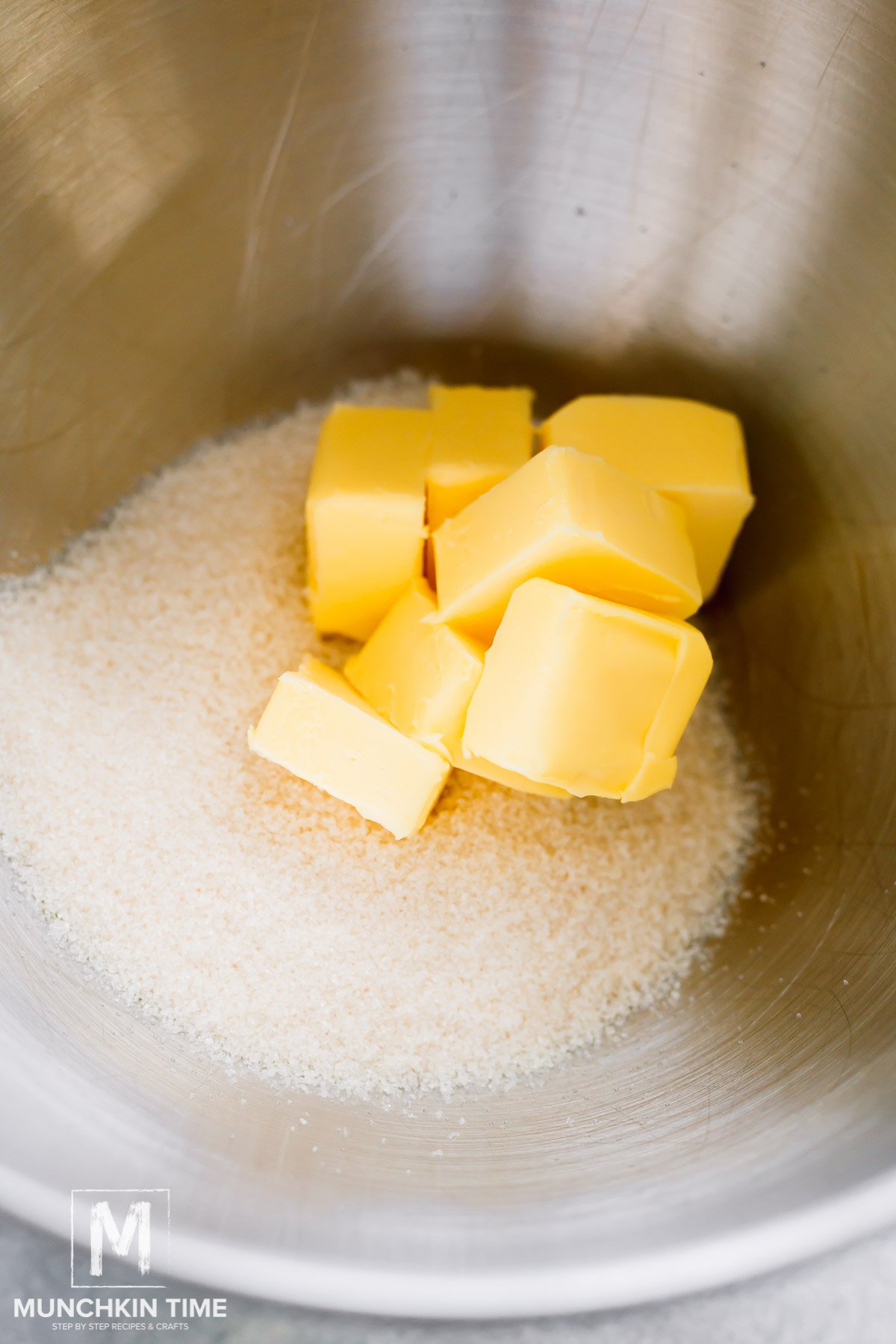 butter and sugar in a bowl, ready to be whisk in a stand mixer.