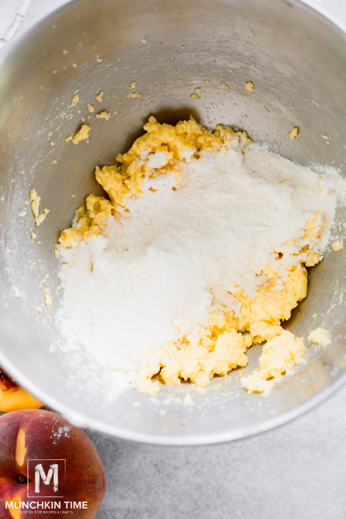 Dry ingredients added to the bowl with butter sugar and egg mixture.