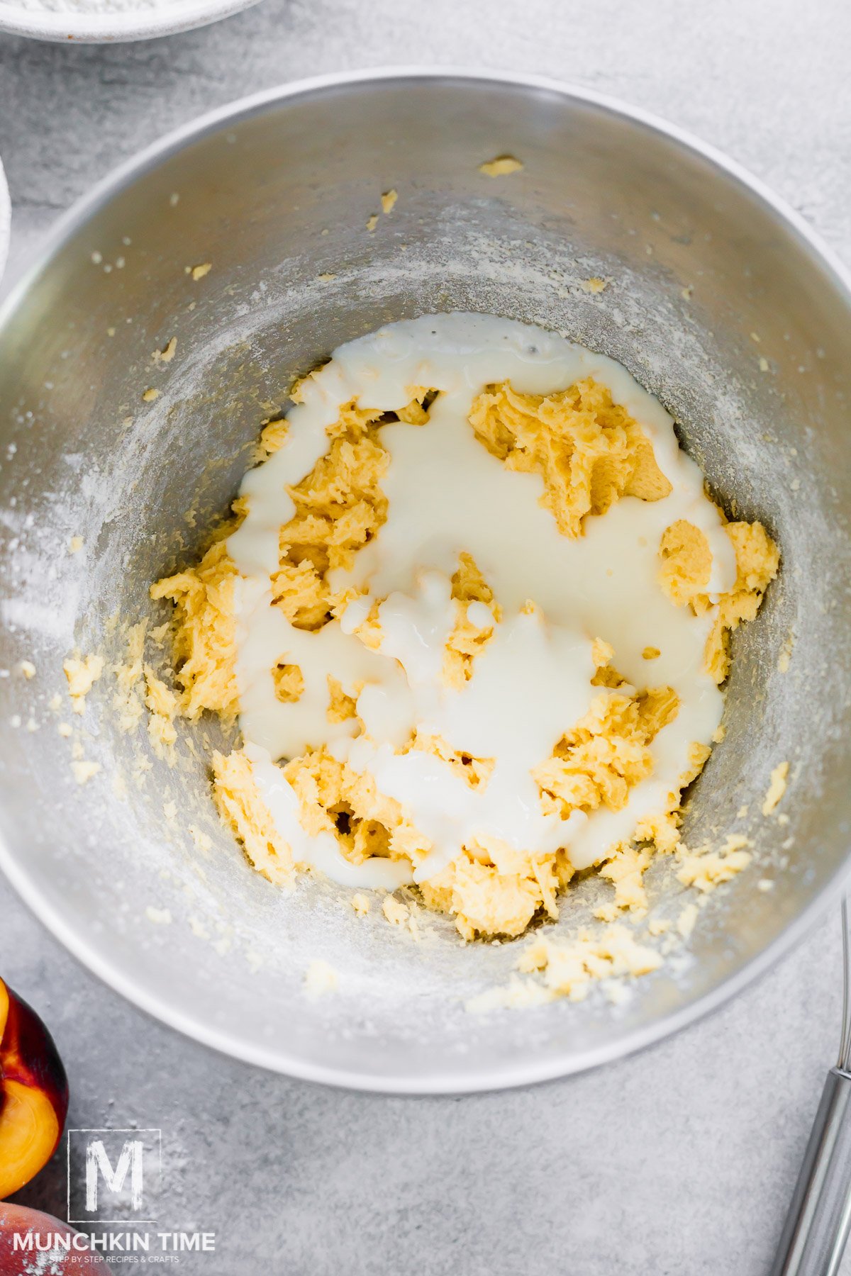 Buttermilk poured into the bowl with the cake batter.