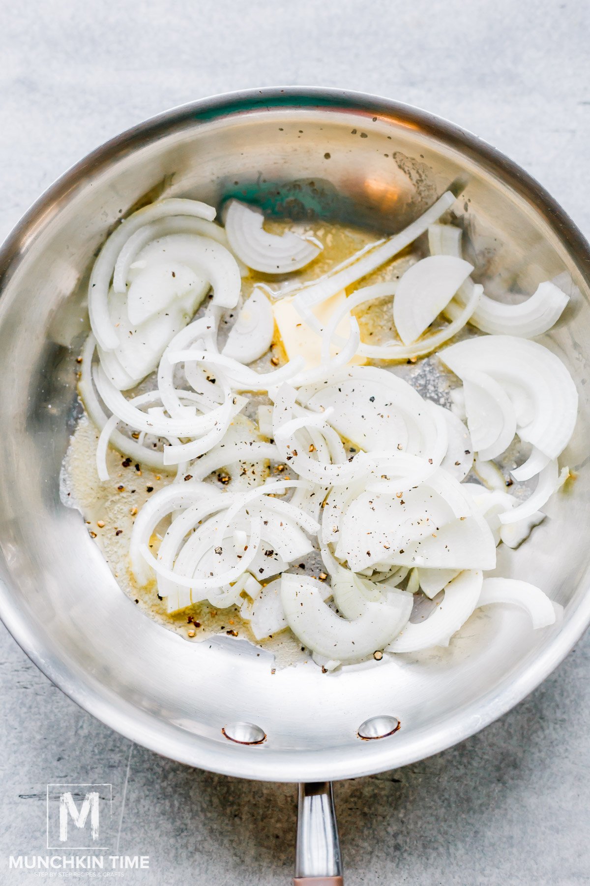 Onion added to the skillet with melted butter.