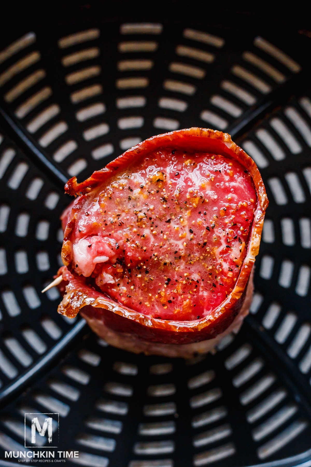 raw steak placed in the air fryer ready for cooking.