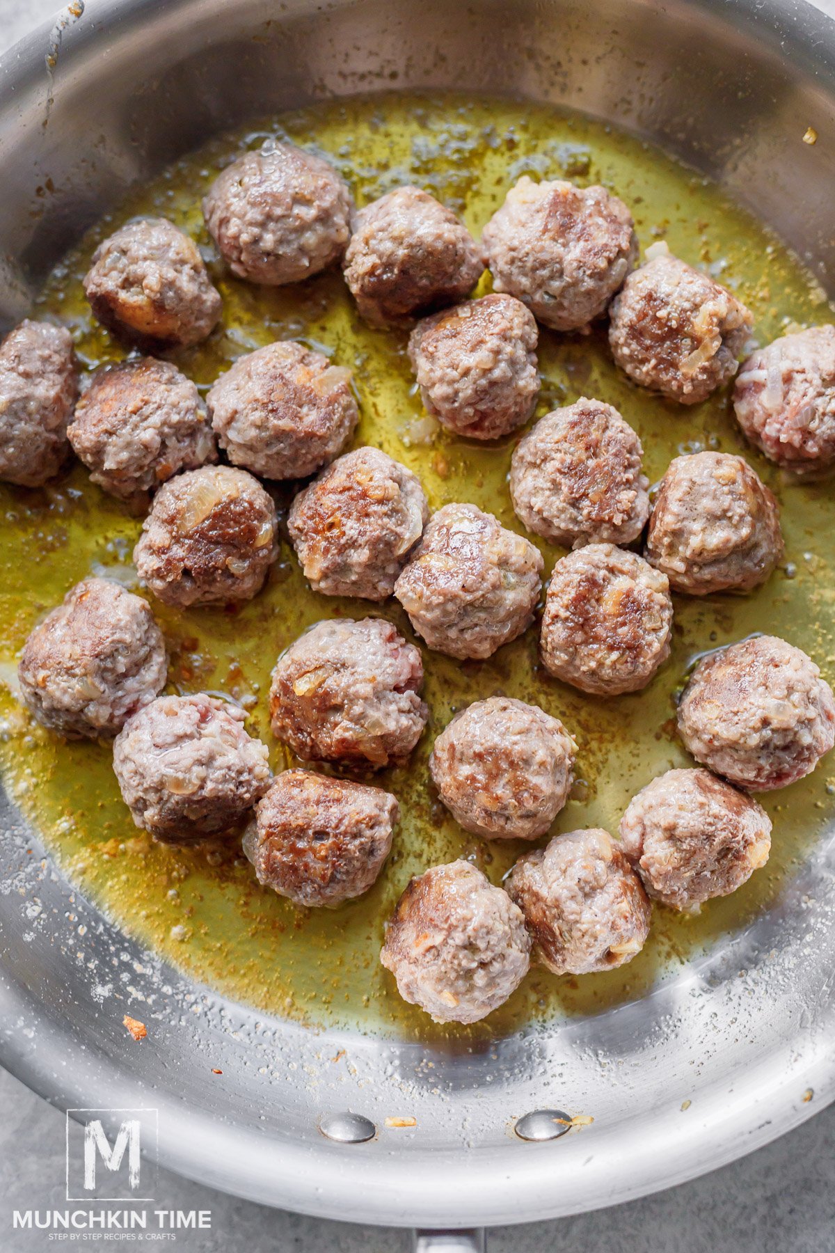  meatballs done cooking in the skillet.