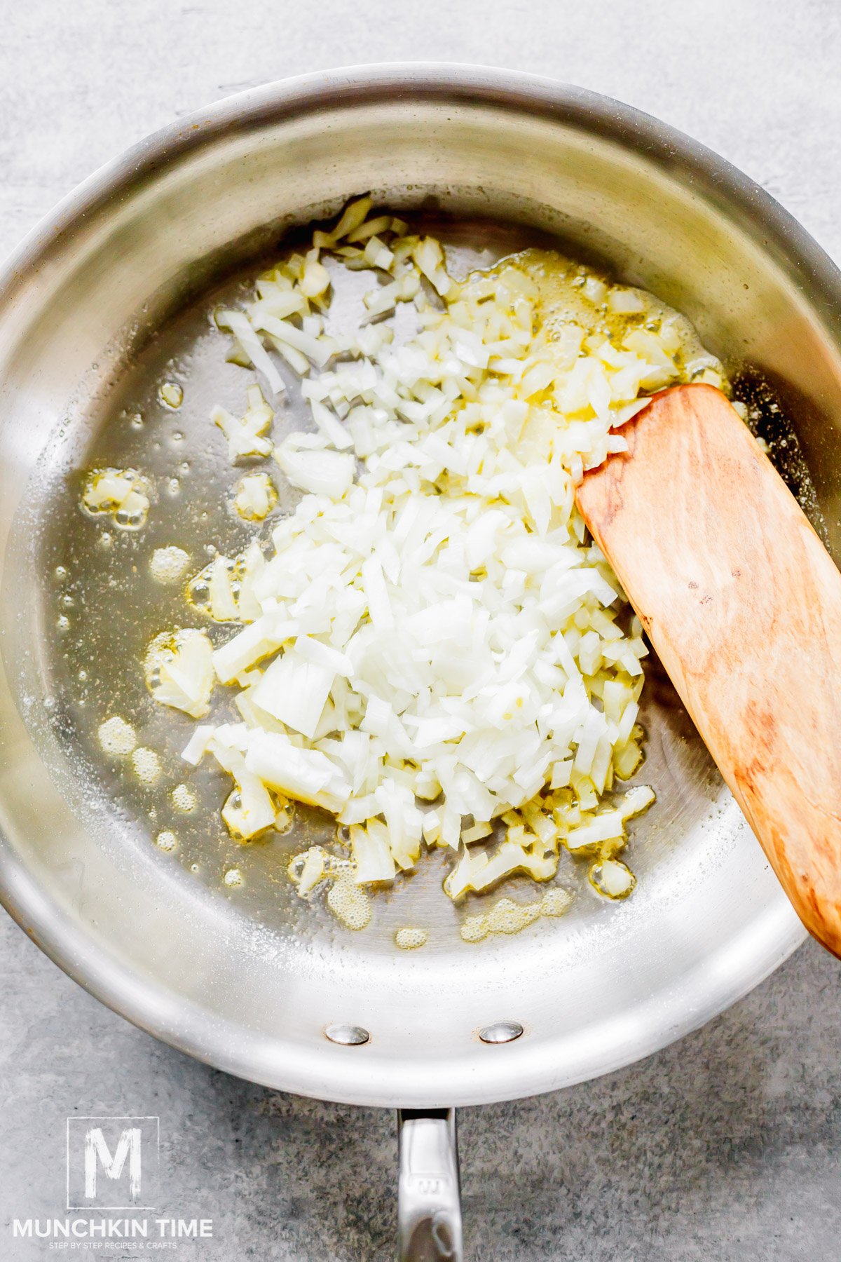 Sautéing onions in melted butter.