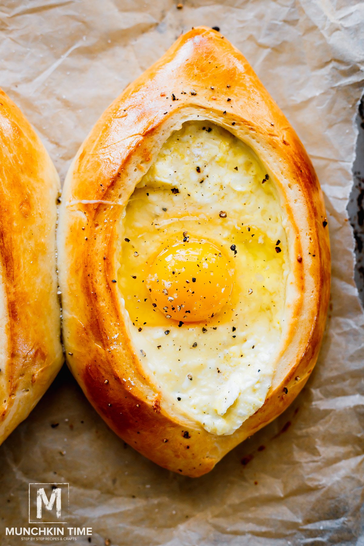 an egg added to the center of the Khachapuri.