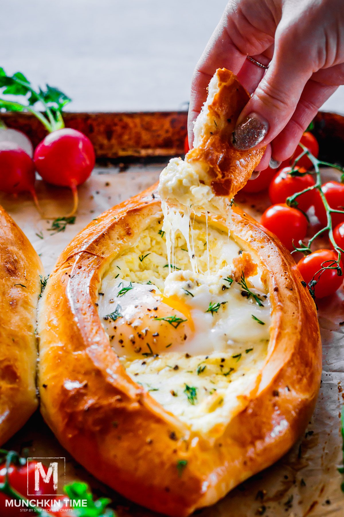 bread dipped in the center of Khachapuri Georgian Cheese Bread