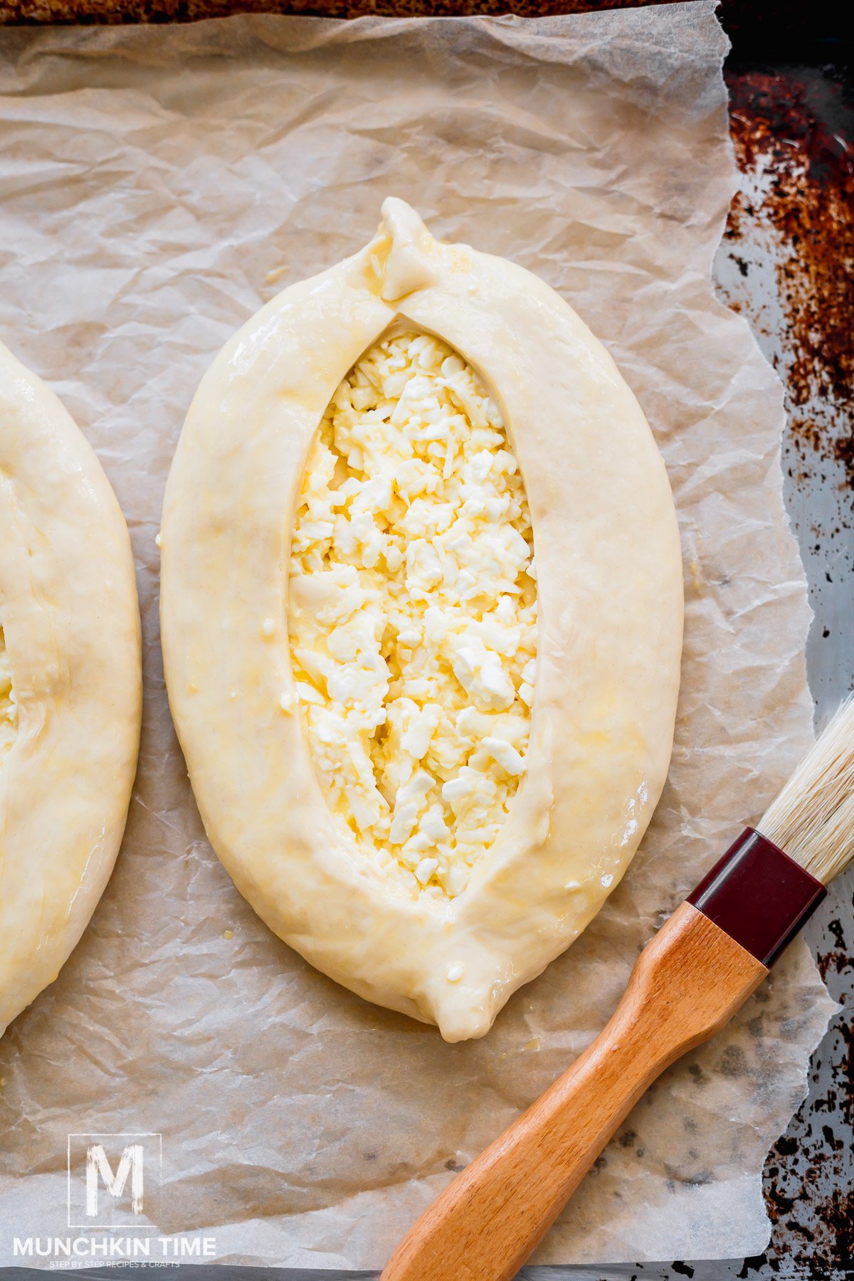 Khachapuri brushed with egg wash.