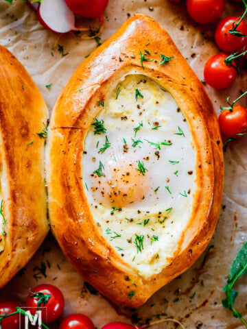 Baked Khachapuri Georgian Cheese Bread with egg in the center.