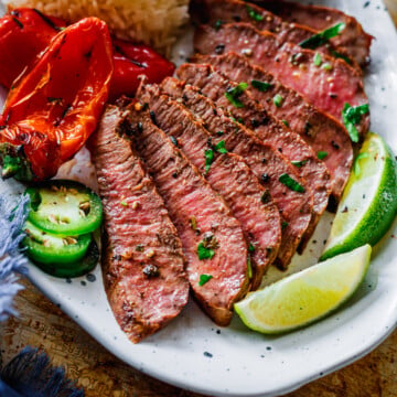 The Best Carne Asada grilled and served with salsa, rice, jalapeno and grilled bell peppers.