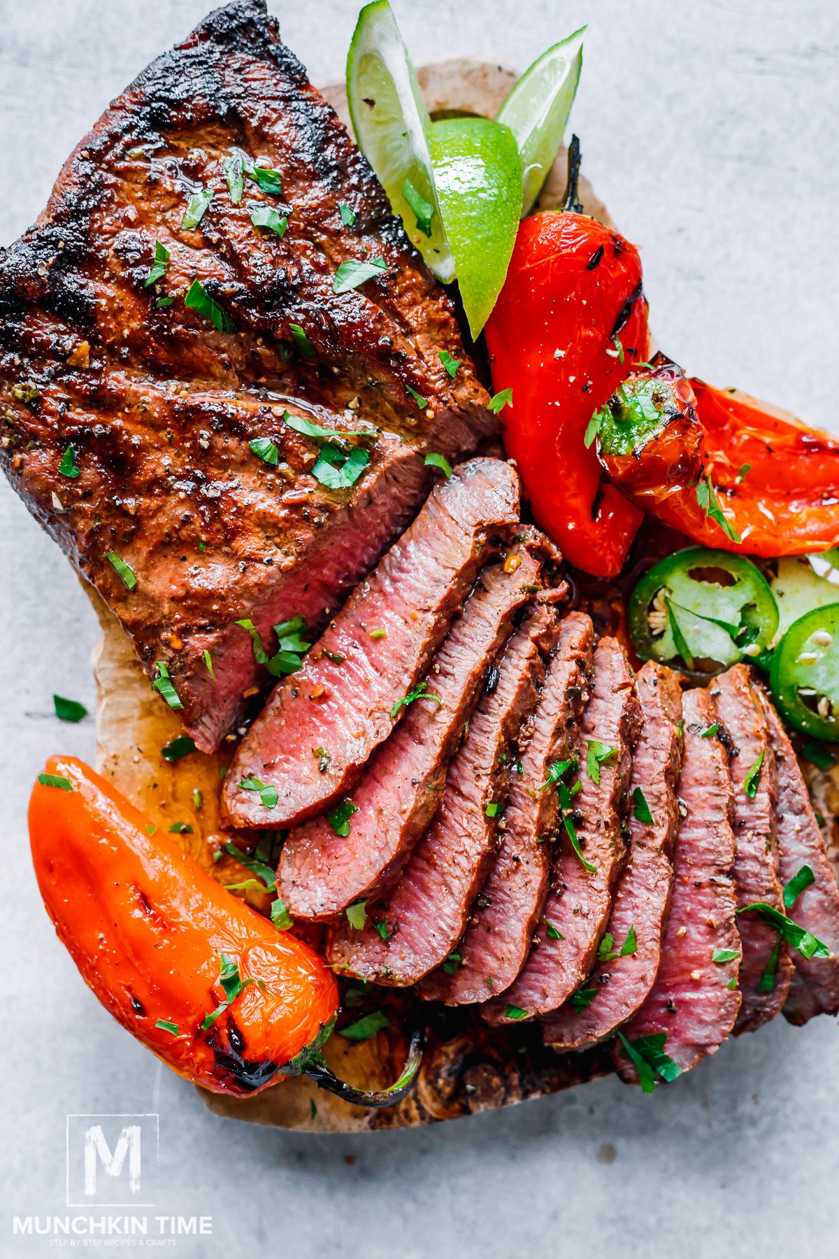 carne asada steak sliced on a cutting board and ready to be served.