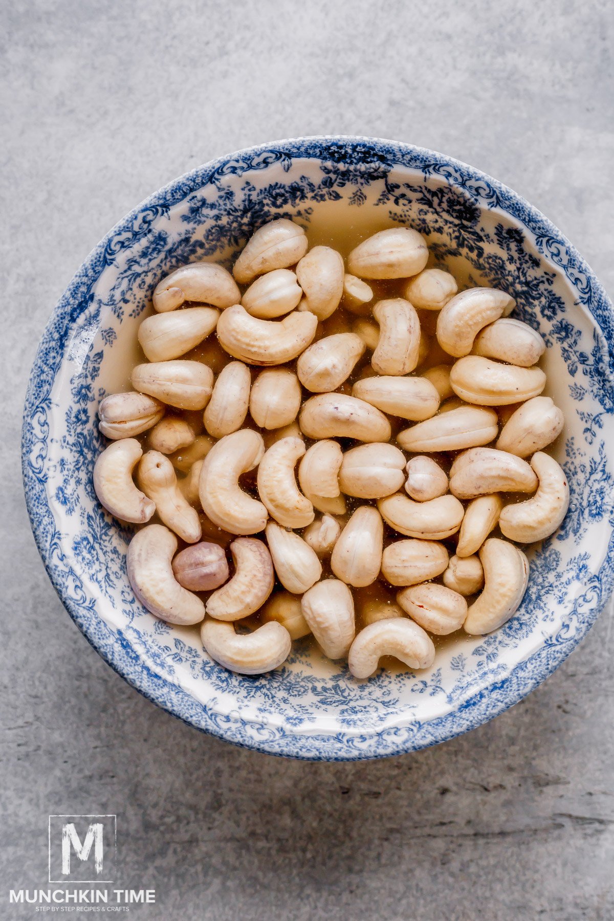 cashews soaking in a bowl with water.