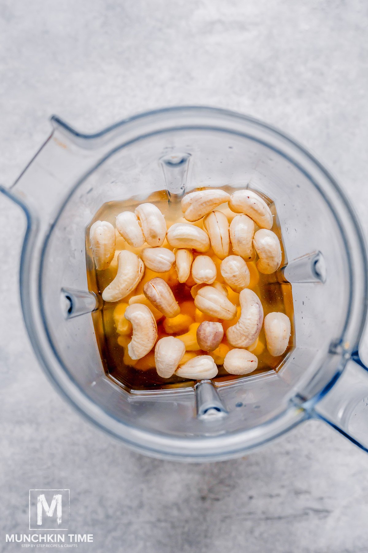 cashews inside the blender with water, vanilla and maple syrup.