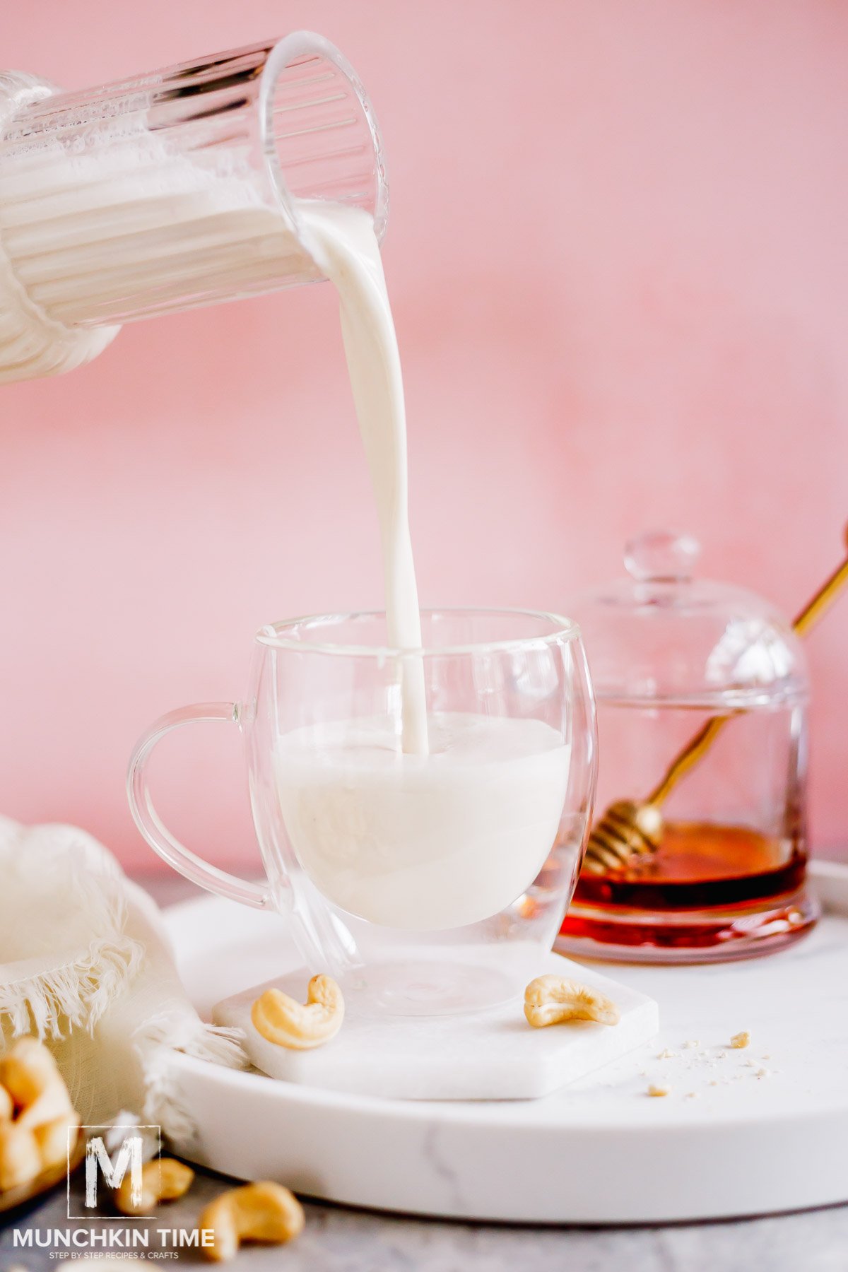 Creamy Cashew Milk being poured into the glass.