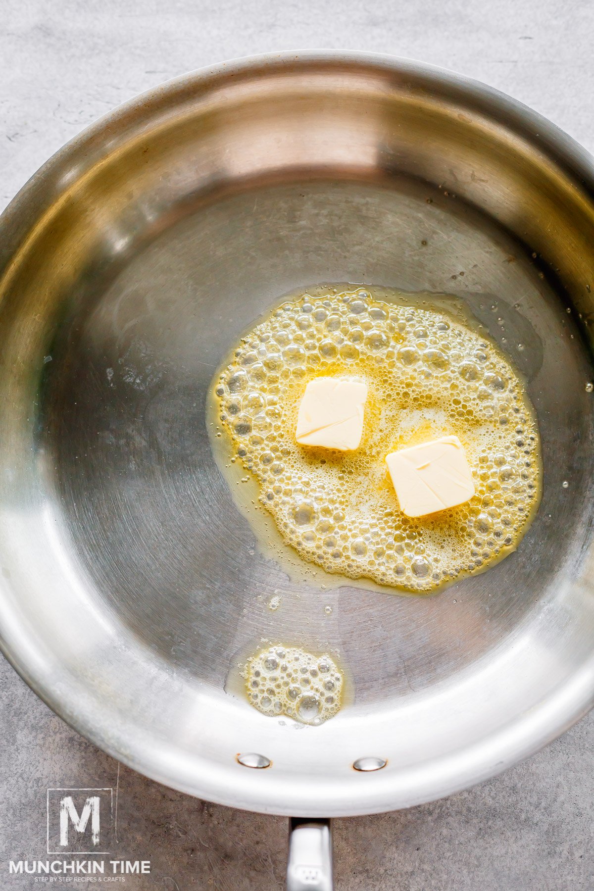 butter melting in the stainless steel skillet. 